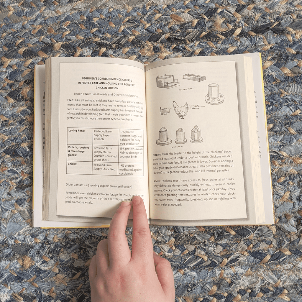 Bookstagram photo featuring UNUSUAL CHICKENS FOR THE EXCEPTIONAL POULTRY FARMER by Kelly Jones. The book lies open on a braided rug. Illustrations of different kinds of chicken feeders and waterers are paired with information on the caring and feeding of poultry. Elza's left hand rests on the page to keep it open.
