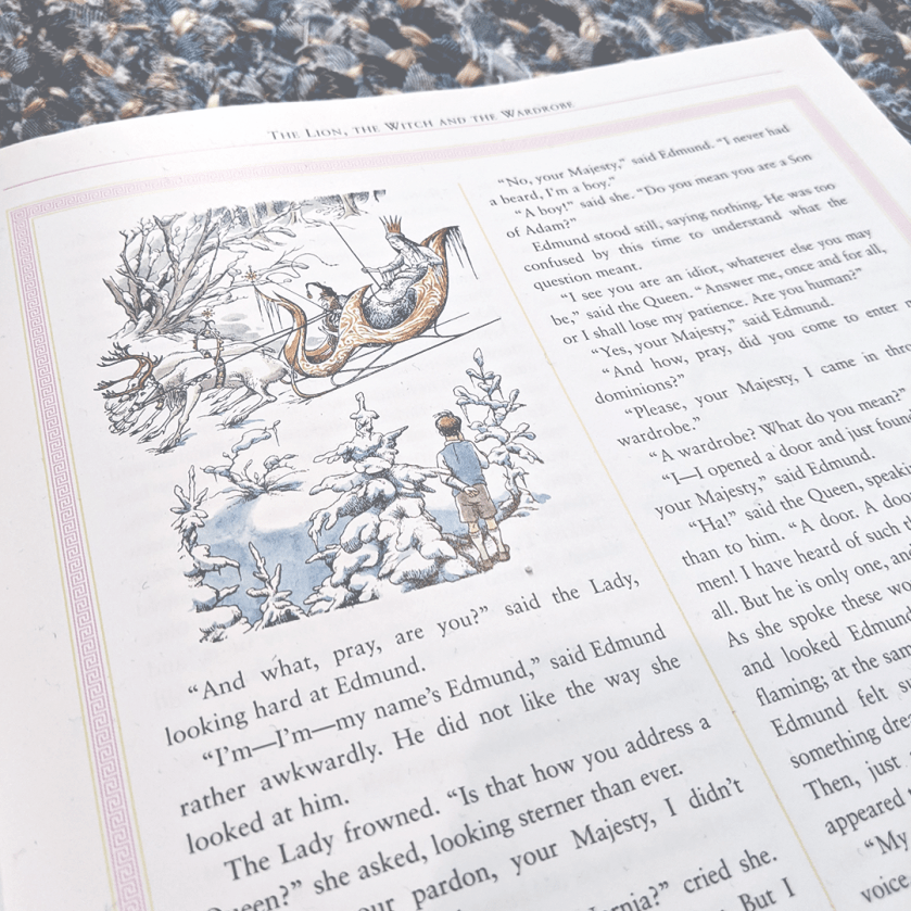 Bookstagram photo featuring an interior illustration from The Lion, The Witch, and the Wardrobe by C. S. Lewis. The illustration features Edmund and the White Witch in her sleigh.